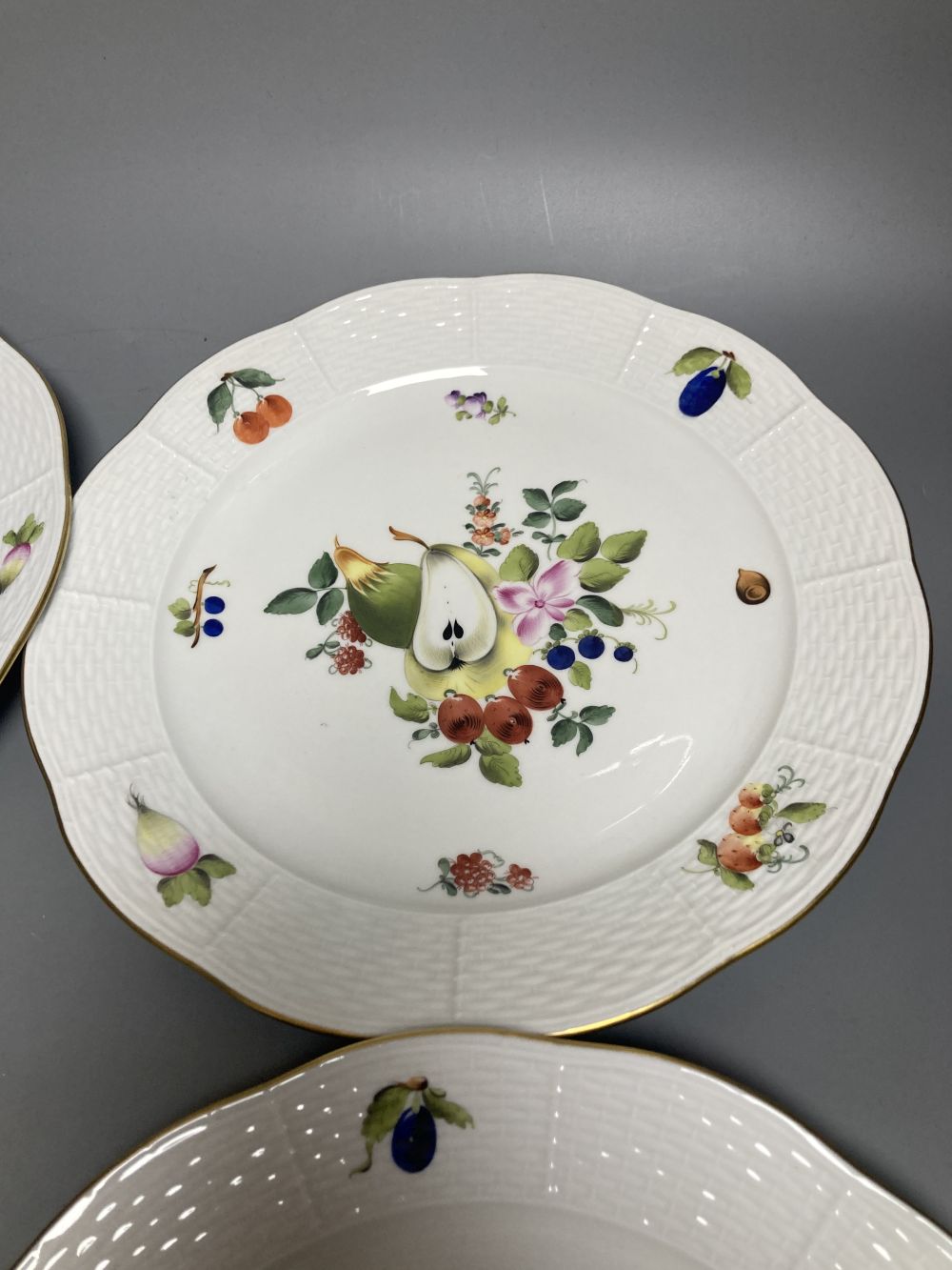 A set of four Herend Meissen style floral painted dessert dishes, diameter 25.5cm